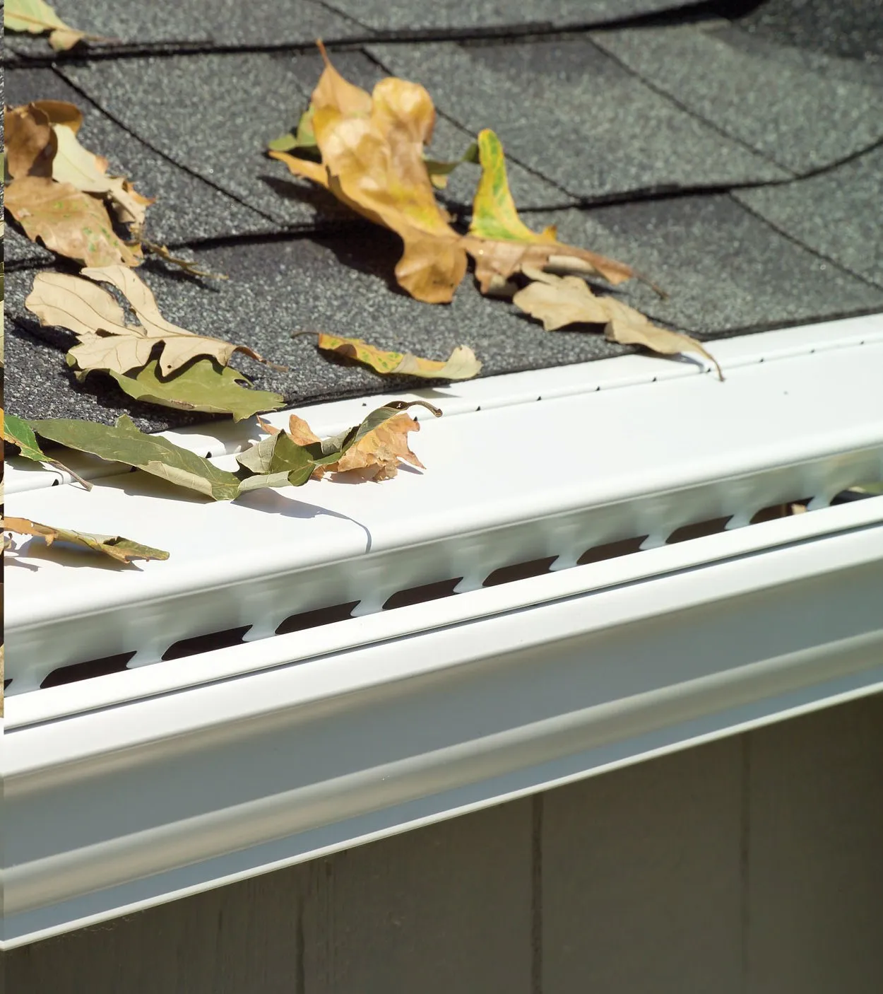 A clean gutter with LeaFree installed, shedding leaves instead of collecting them.